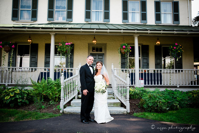 Bride and Groom In Front of Historic Manor