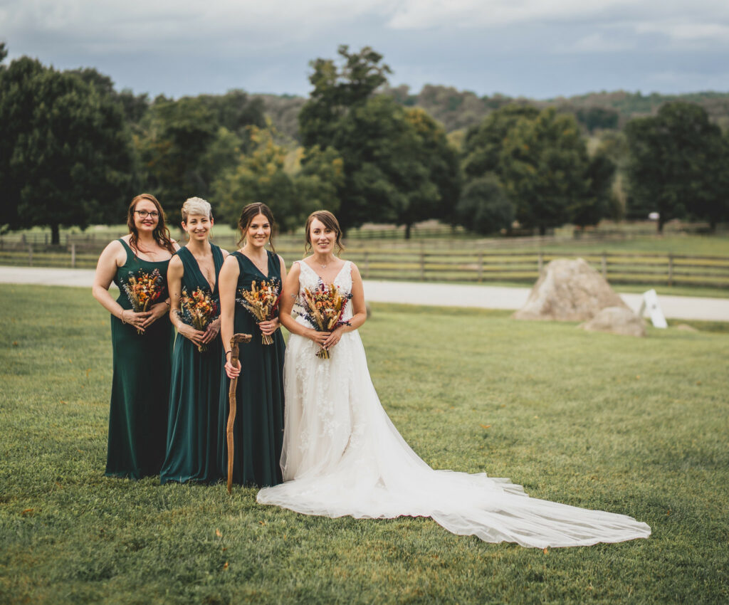 Bride and Bridesmaids posing in the field