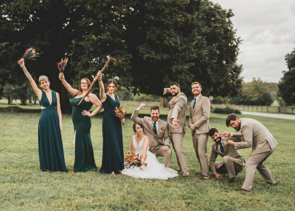 Bridal party posing in the field.