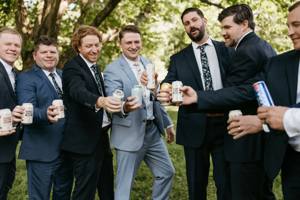 Groom and groomsmen drinking beer.