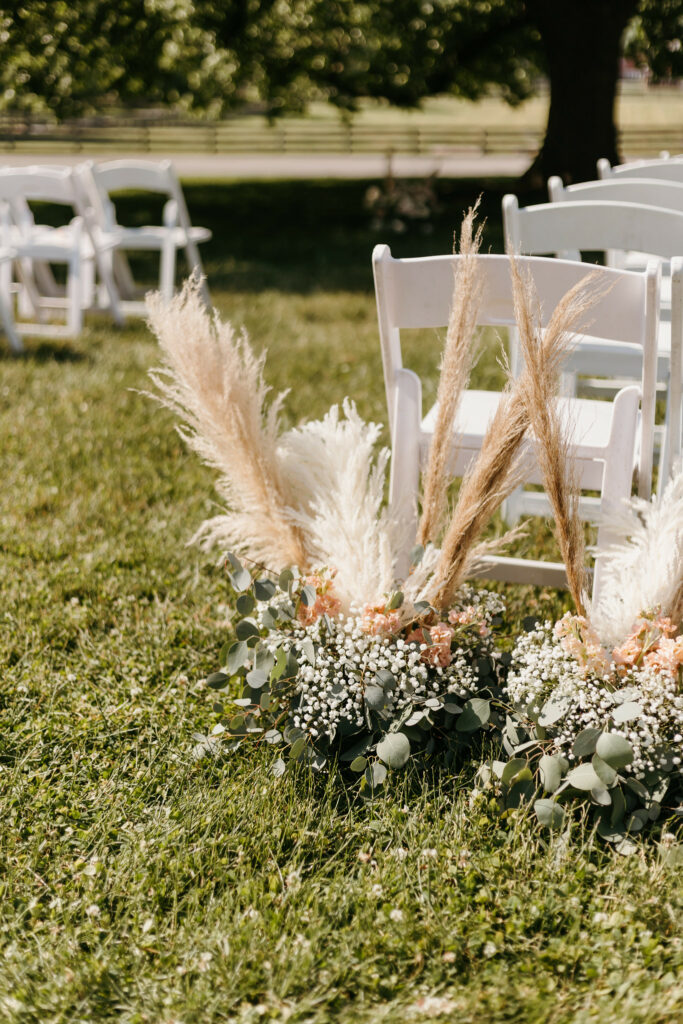 Ceremony decor, greenery and tall grass.