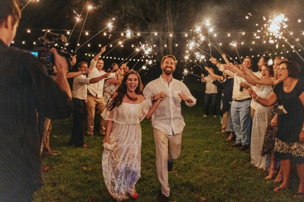 Newlyweds exit through guests and sparklers.