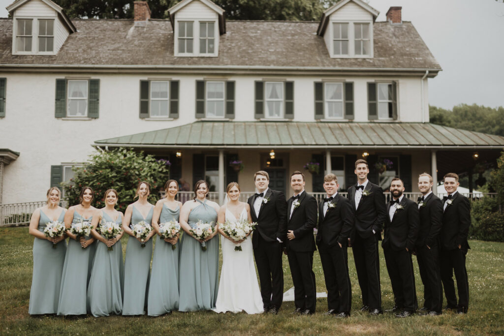 Bridal party posing in front of the Manor House at Springton Farm.