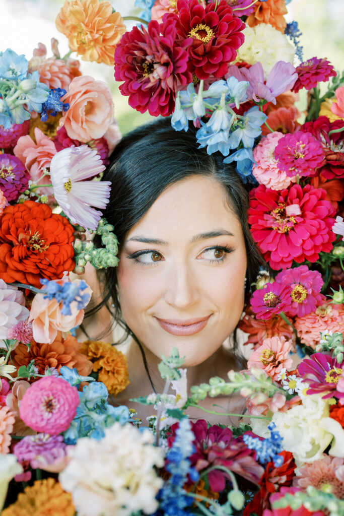Brides face surrounded by bouquets.