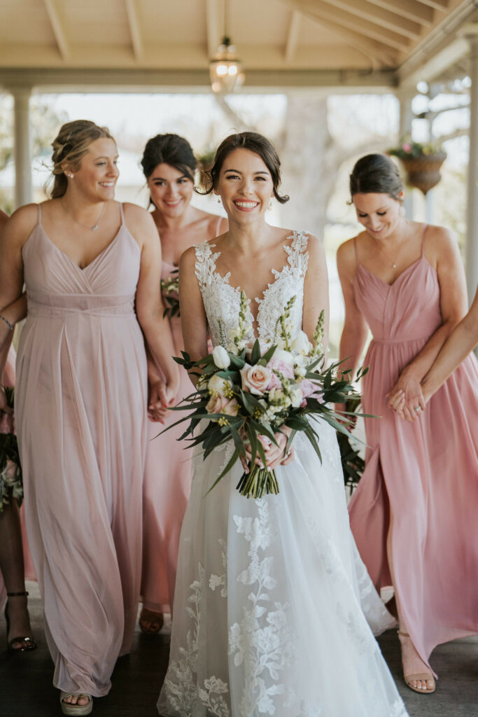 Bride with bridesmaids and bouquet.
