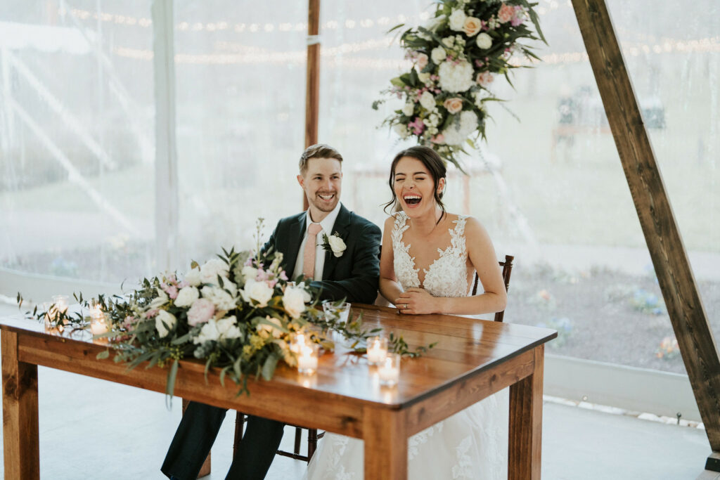 Newlyweds sitting at their sweetheart table.