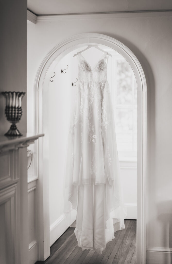 Wedding dress hanging in the doorway of the private bridal suite at Springton Manor Farm