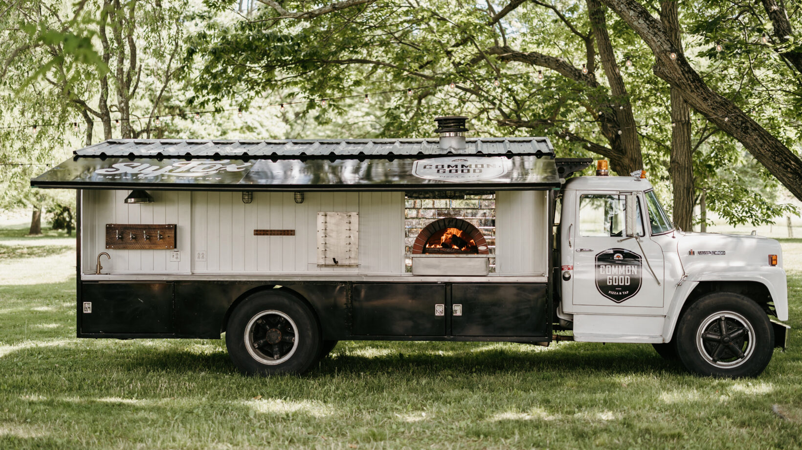 Wood fired pizza catering truck on lawn