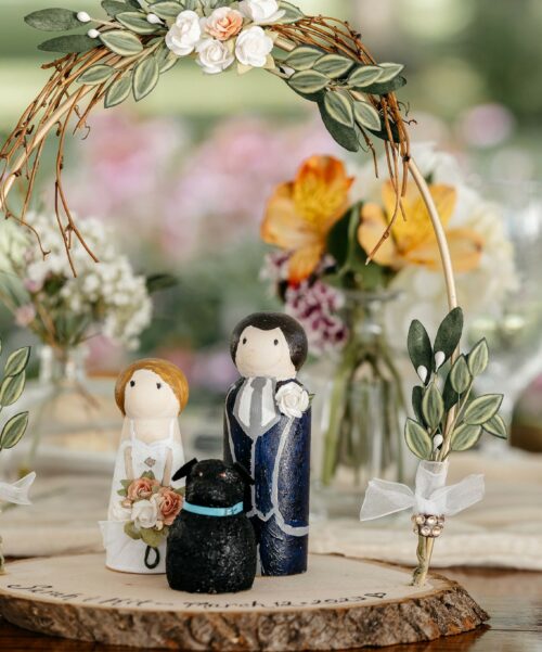 Wooden toy of the couple at the alter.