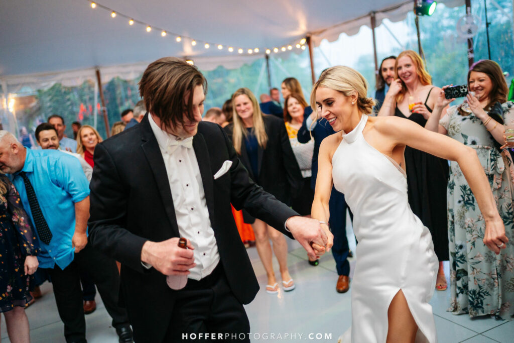 Newlyweds dancing with guests.