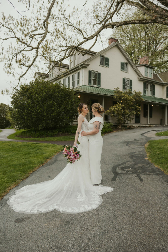 Newlyweds embracing infront of Springton Manor Farms.