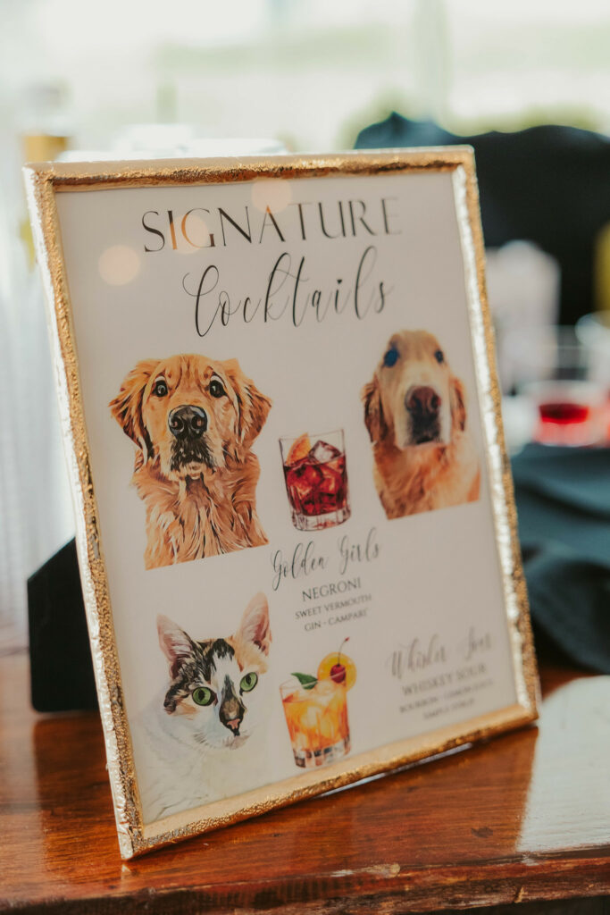 Cocktail sign on bar with their pets photos , two golden retriever's and a cat.