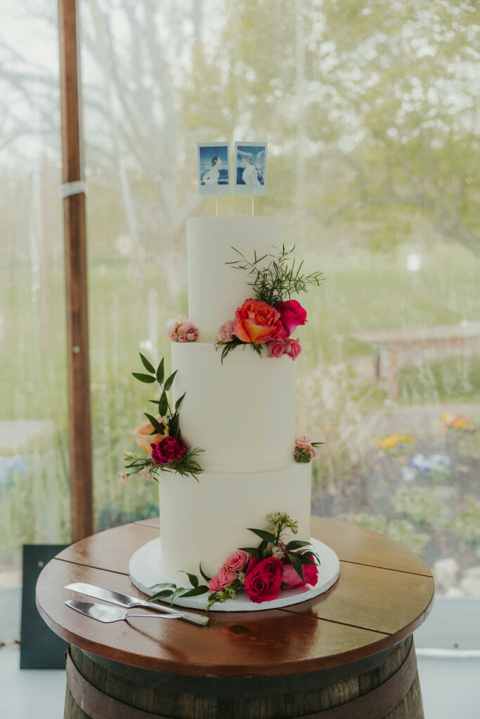 Tiered layered wedding cake with flowers on each layer.