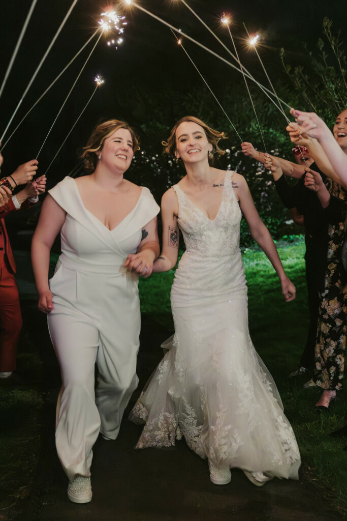 Newlyweds leaving their receptions surround by guests and sparklers.