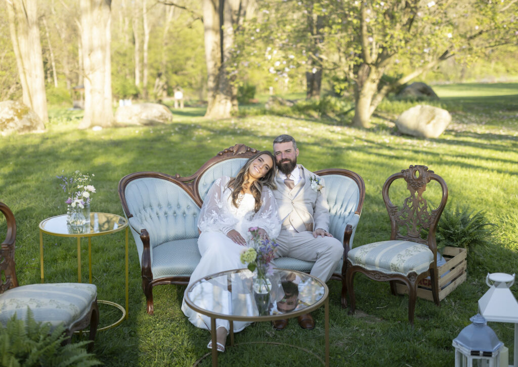 Newlyweds cuddling in the lounge group.