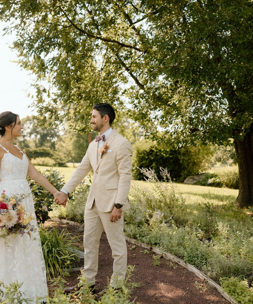 bride and groom holding hands